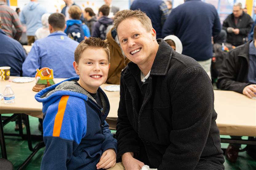 Trinity Elementary students eat donuts with dudes